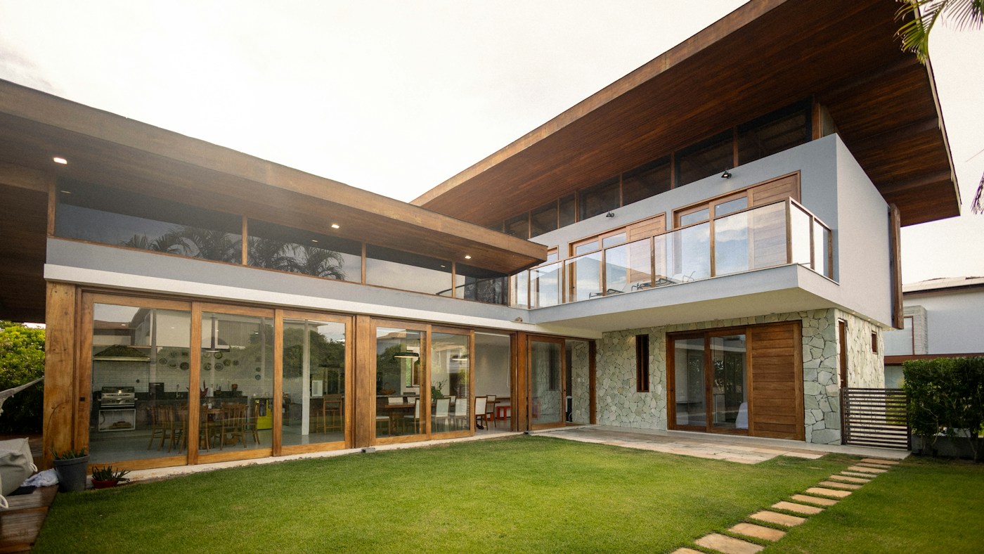 Illustrative contemporary home with large windows and a lawn; not an active listing